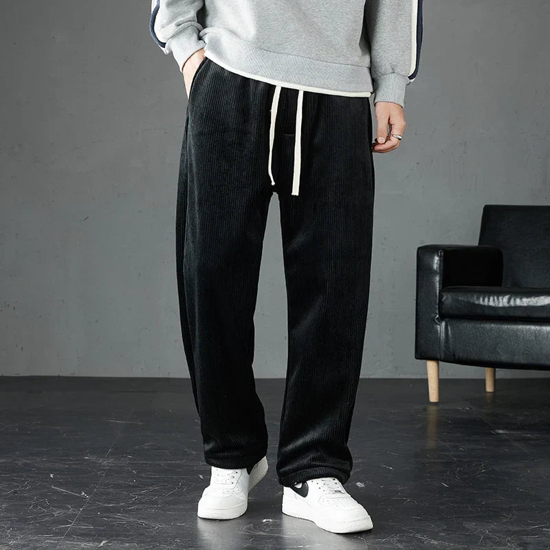 Model wearing men's comfortable corduroy joggers, showcasing their relaxed fit, perfect for lounge or fall fashion.