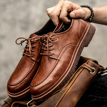 Men's sophisticated brown leather dress shoes, perfect for formal events or elegant business wear. Classic slip-on design.
