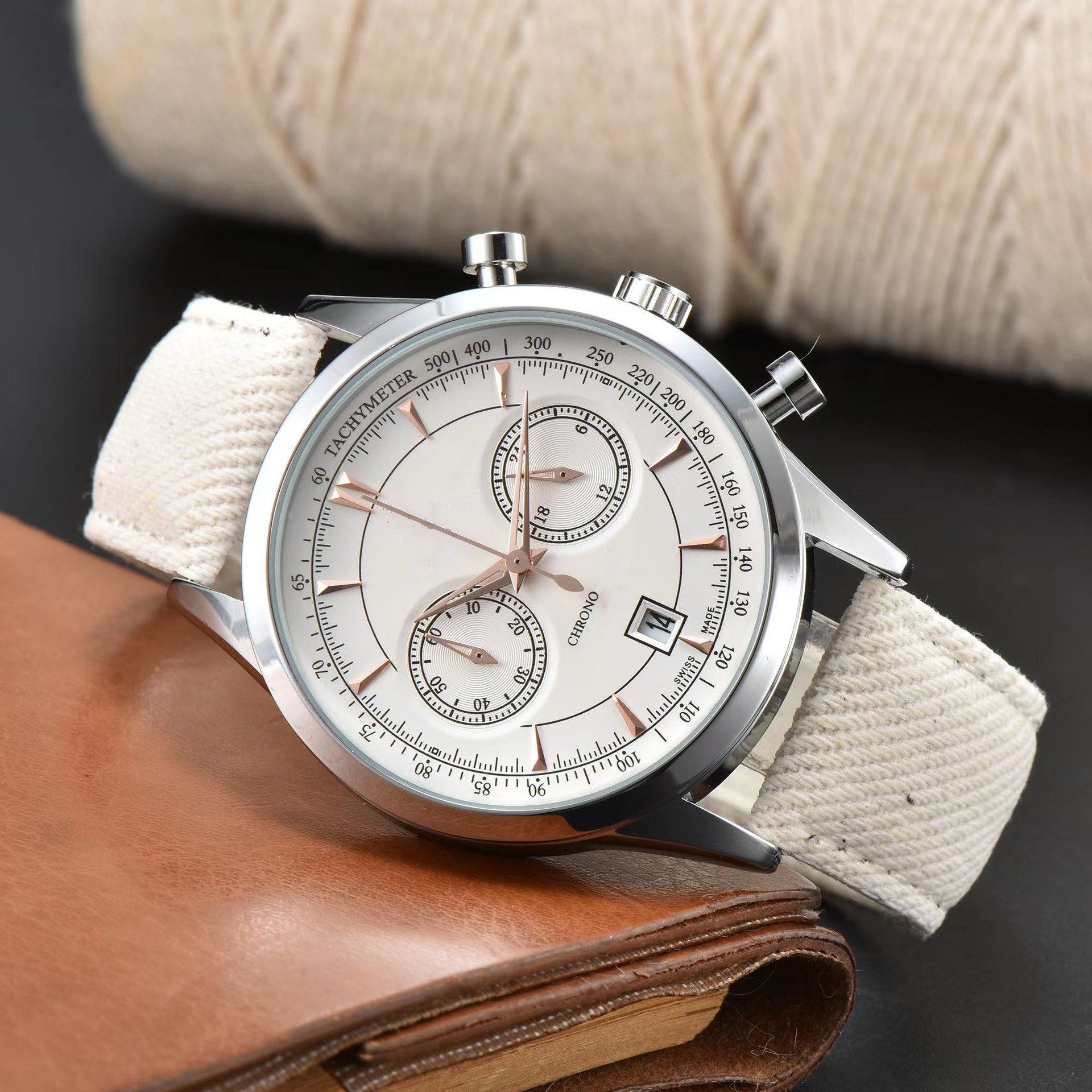 Modern men's chronograph watch featuring a durable stainless steel case and a comfortable canvas strap. Casual wrist accessory.
