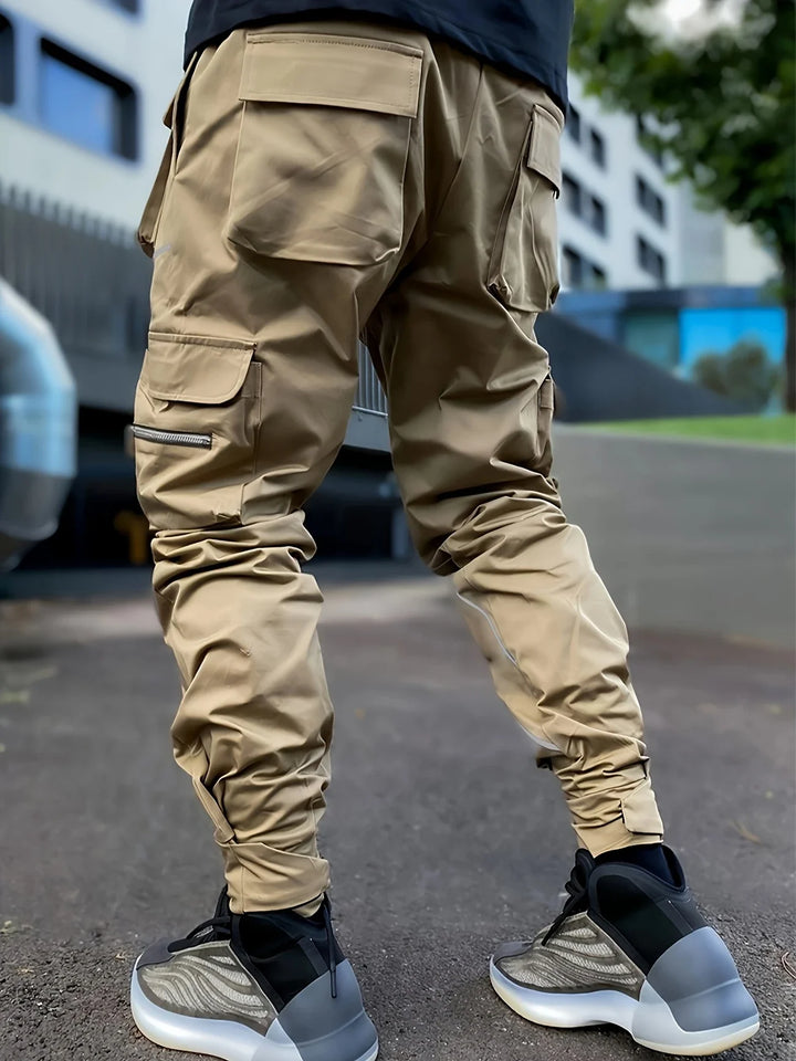 Comfortable elastic waistband and drawstring on men's reflective activewear cargo pants.