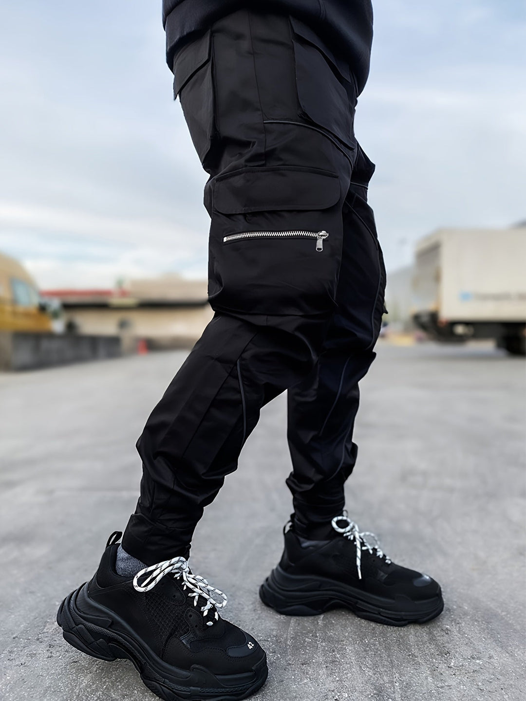 Close-up of reflective strip on men's stealth cargo joggers, enhancing low-light visibility.