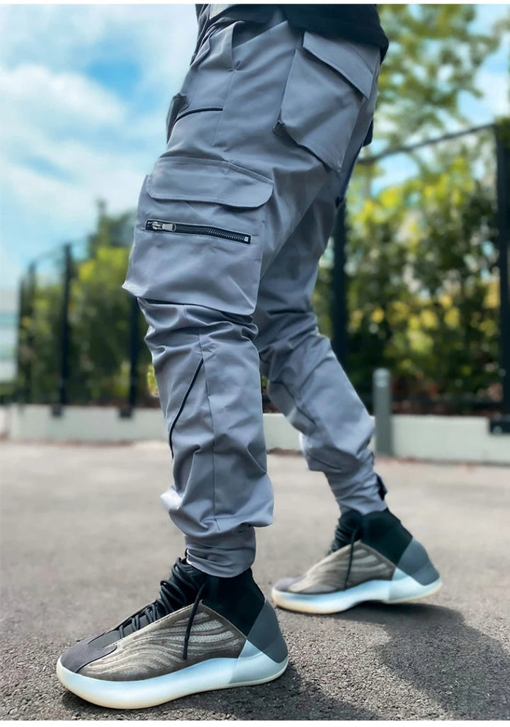 Tapered fit men's reflective joggers, designed for athletic performance and urban streetwear appeal.
