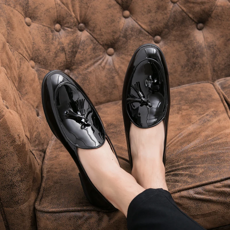 Premium men's blue loafers with black tassels, offering a sharp look for formal and dressy occasions.