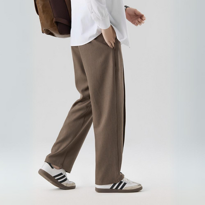 Comfortable men's pleated dress pants, relaxed fit, lightweight sterling fabric, ideal for work.