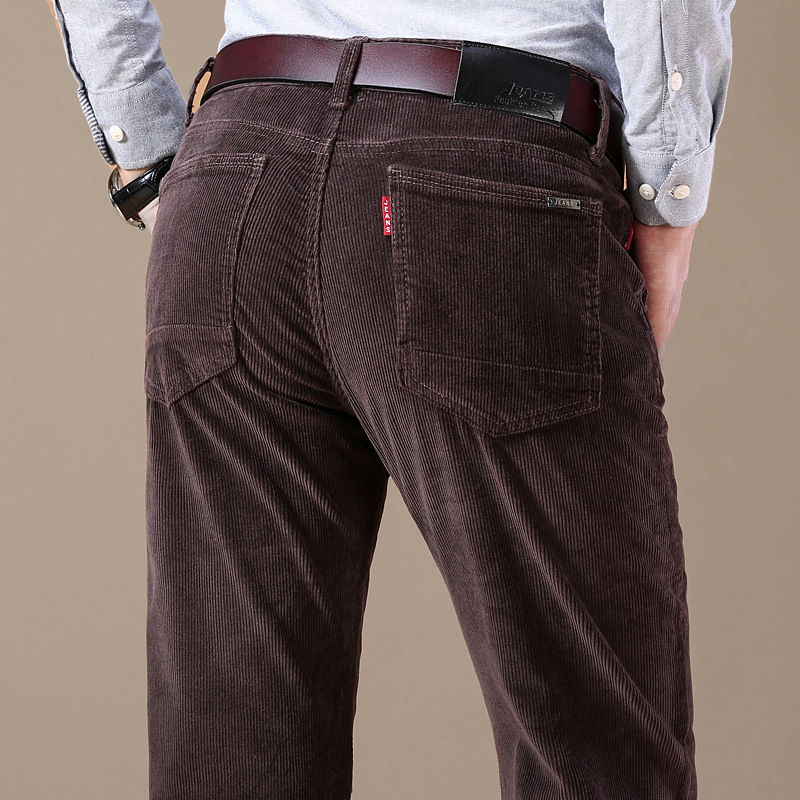 Close-up of waistband and button closure on men's stretch corduroy trousers, quality men's apparel.