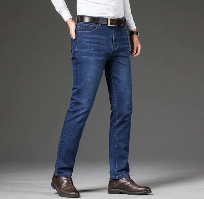 Man wearing versatile stretch straight leg denim jeans, showcasing a comfortable and modern fit.
