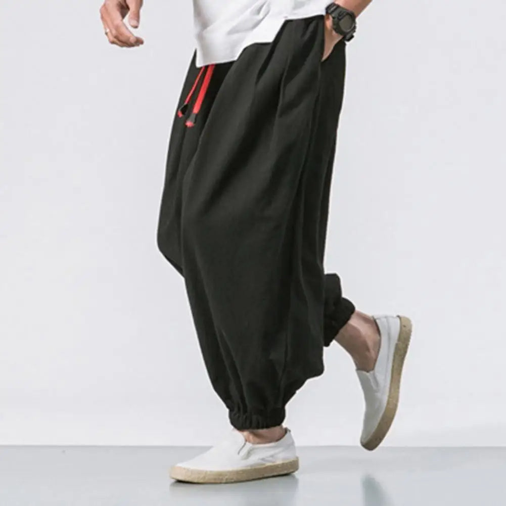 Man wearing Stride baggy harem joggers for activewear; perfect for yoga, lounging, or casual comfort.