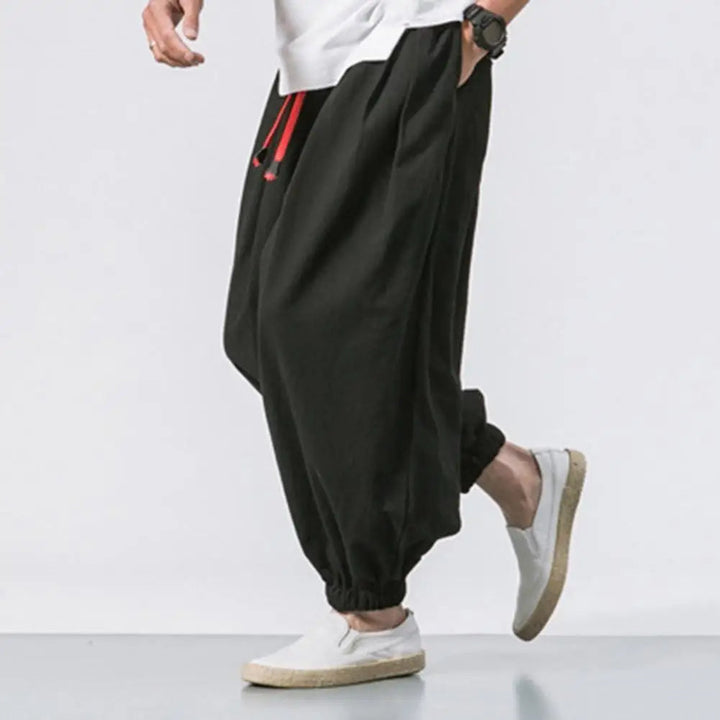 Man wearing Stride baggy harem joggers for activewear; perfect for yoga, lounging, or casual comfort.