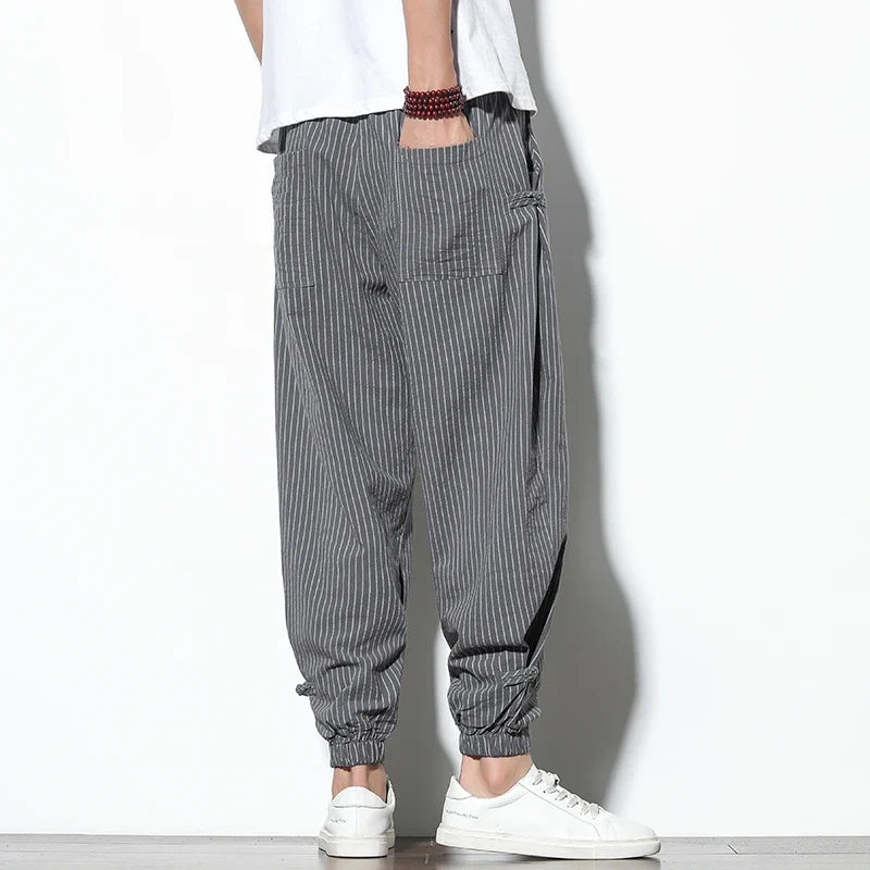 Relaxed fit men's athletic joggers, black with white stripes, perfect for loungewear & streetwear.