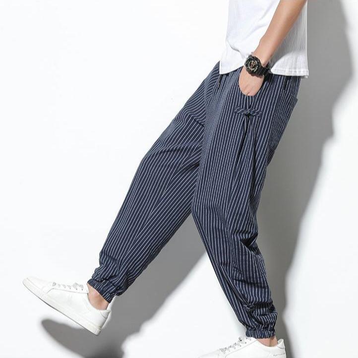 Black men's joggers with subtle side stripes, offering relaxed comfort for casual or active use.