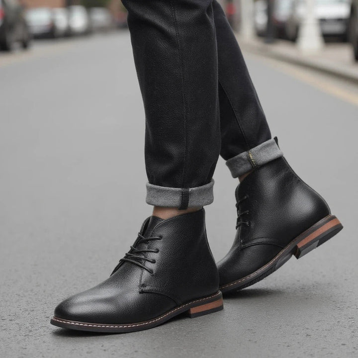 Lace-up men's black chukka boots, combining comfort with a stylish, versatile design.