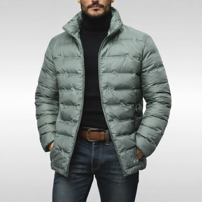 Man wearing a stylish grey puffer jacket, perfect cold weather outerwear for a modern casual look.