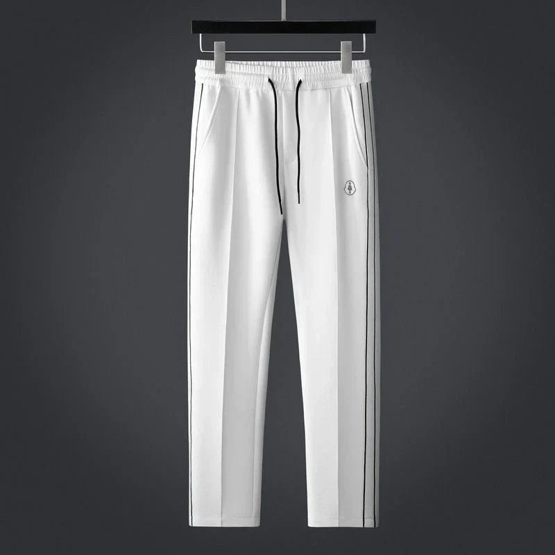 Stylish men's striped activewear set. Modern two-piece athleisure outfit, ideal for fashion-forward comfort wear.