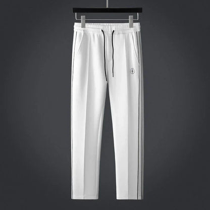 Stylish men's striped activewear set. Modern two-piece athleisure outfit, ideal for fashion-forward comfort wear.