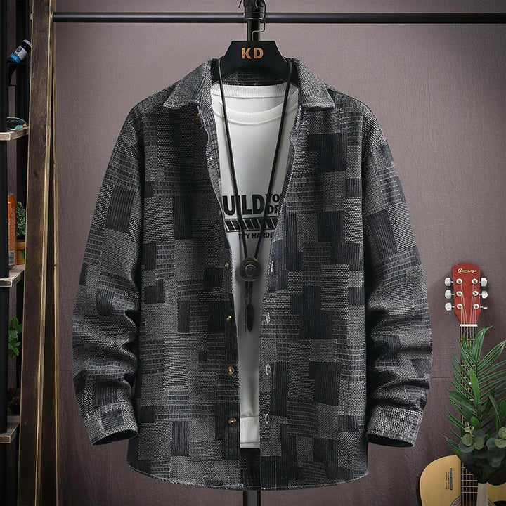 Effortlessly stylish men's relaxed fit patchwork denim shirt with snap closures. Perfect for modern casual looks.
