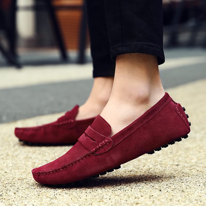 Man walking in stylish men's slip-on loafers, offering ultimate comfort and sophisticated casual footwear.