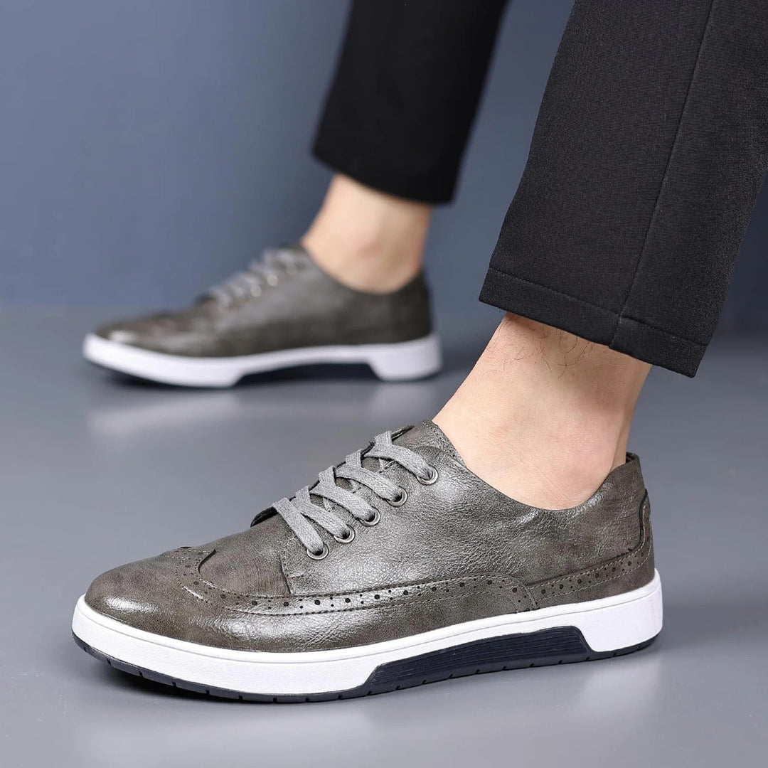 Classic men's brogue sneakers with intricate detailing, versatile for dress or casual wear. Comfortable footwear.