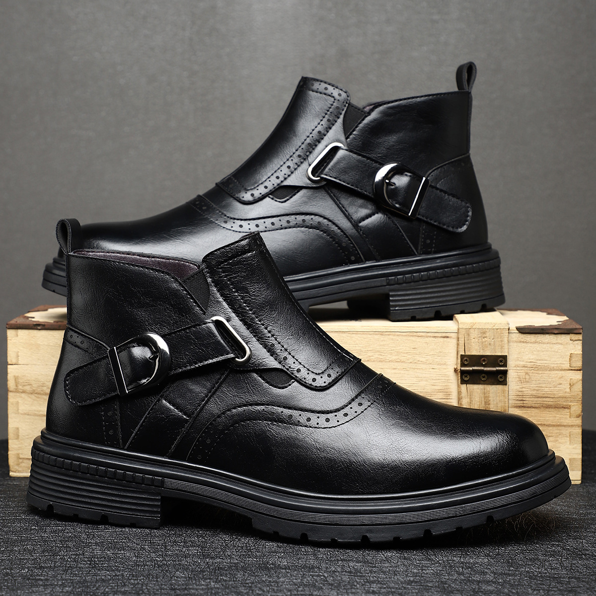 Close-up of classic brogue detailing on men's stylish leather ankle boots, ideal for dress or casual wear.