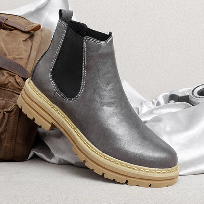 Assortment of men's Chelsea boots in brown, black, and gray, displaying color options.