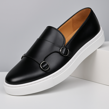 Close-up of men's monk strap loafers, showcasing buckle detail & fine leather finish. Quality footwear.