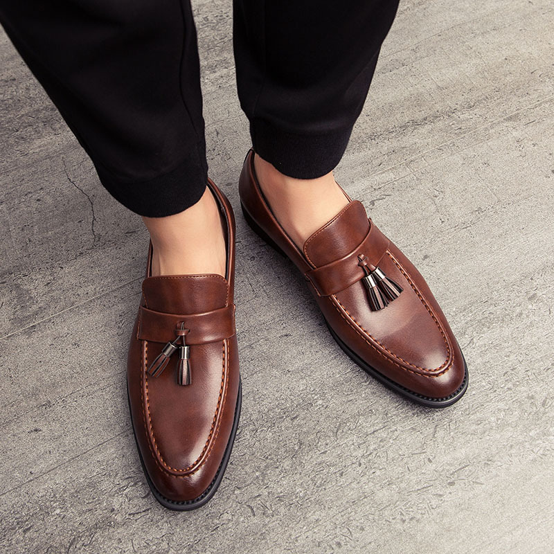 Classic men's navy suede tassel loafers. Sophisticated slip-on dress shoes for refined men's fashion.