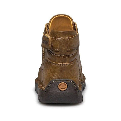 Close-up of men's black PU leather ankle boots with durable non-slip sole for outdoor adventures