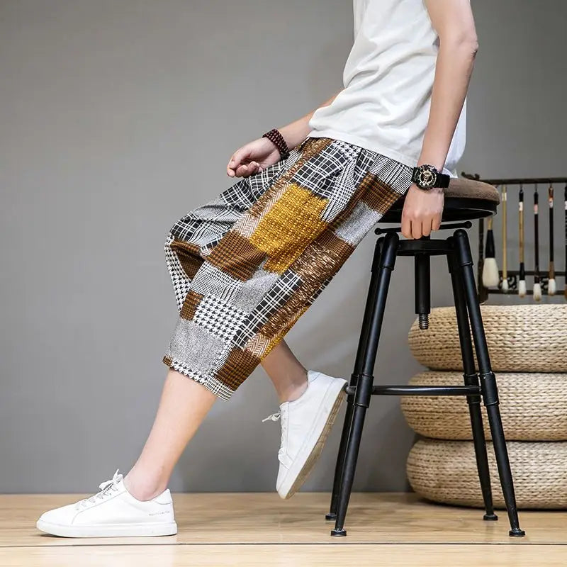Durable men's khaki capris shorts with unique patches and an adjustable waist for summer fashion.
