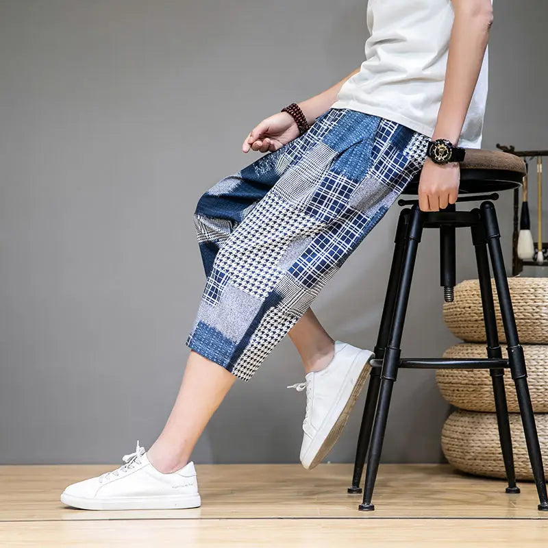 Blue men's capris shorts featuring a unique patch design, offering a stylish look for casual wear.
