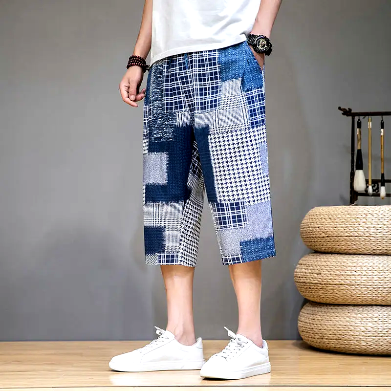 Men's comfortable capris shorts with unique patch detailing, great for casual summer activities.