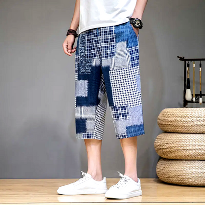 Men's comfortable capris shorts with unique patch detailing, great for casual summer activities.