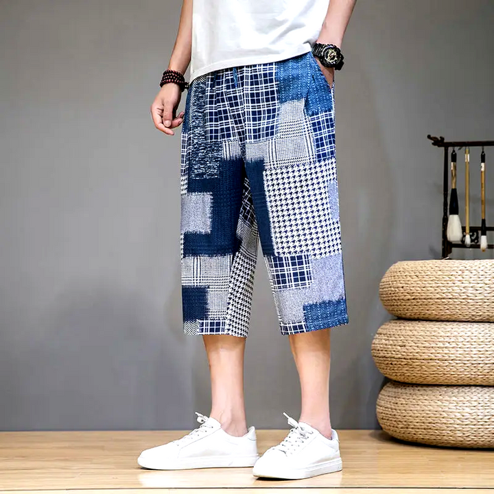 Men's comfortable capris shorts with unique patch detailing, great for casual summer activities.