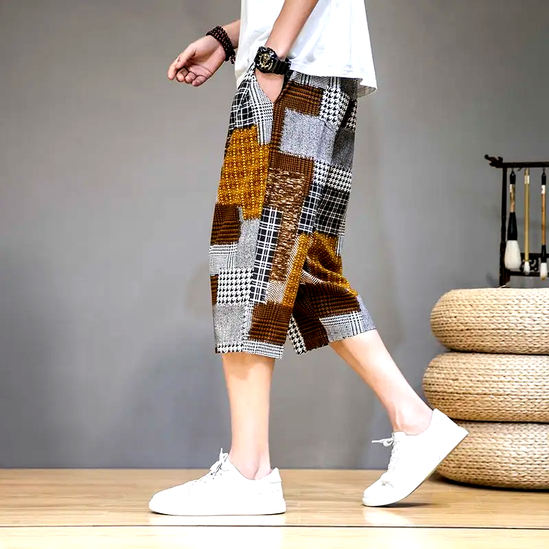 Stylish men's gray capris shorts featuring unique patches and an adjustable waist for comfort.