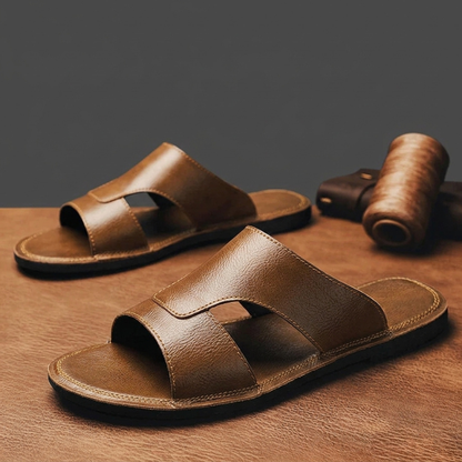 Slip-on men's casual sandals with black cross-straps, offering comfort for warm weather & vacation.