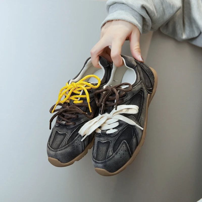 Modern men's casual footwear: comfortable, stylish sneakers with innovative double lace design for all-day wear.