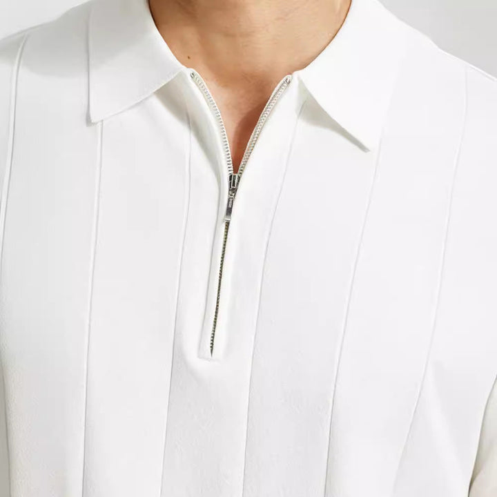 Dynamic shot of a man wearing a stylish half-zip polo shirt, showcasing its modern fit and comfort.