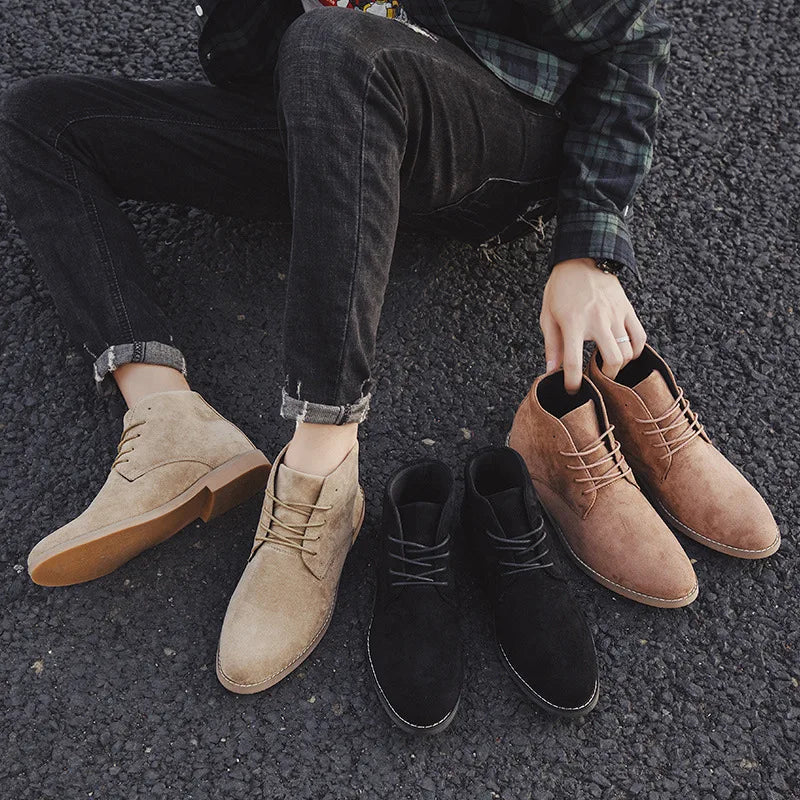 Close-up of durable black leather men's lace-up Chelsea boots, showcasing quality material & rugged stylish design.