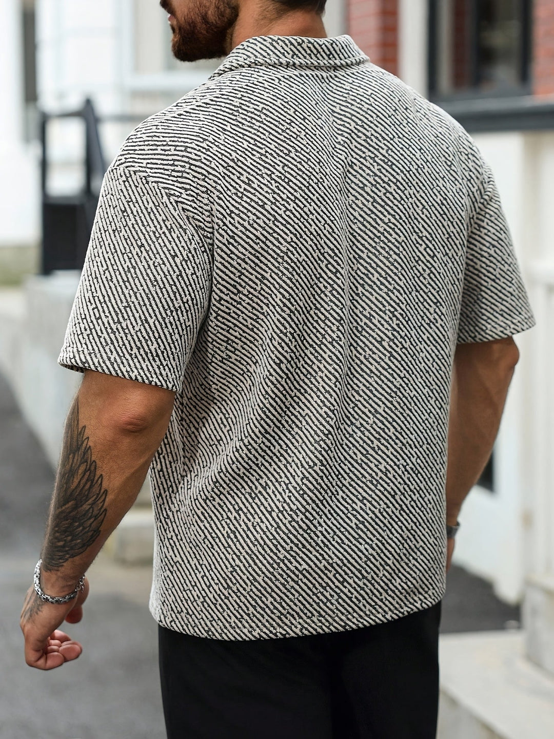 Relaxed fit men's Monaco polo with open collar, textured short sleeve, ideal for warm weather comfort and summer fashion.