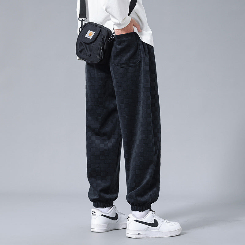 Fashionable men's checkerboard design sweatpants, featuring a relaxed fit for ultimate style and comfort.