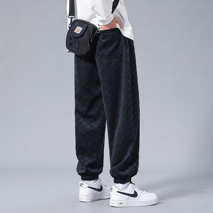 Fashionable men's checkerboard design sweatpants, featuring a relaxed fit for ultimate style and comfort.