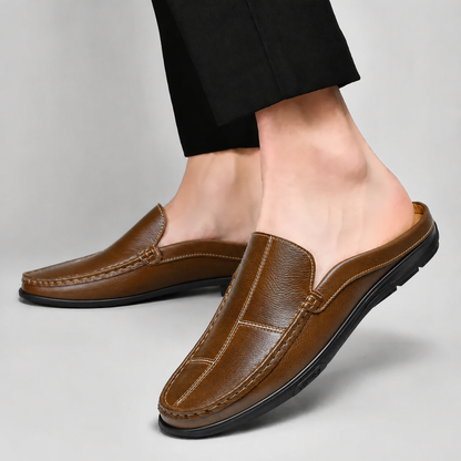 Black men's stylish comfort mules, an essential slip-on shoe for any casual outing.