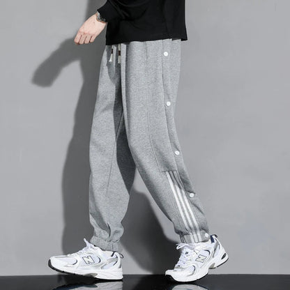 Modern men's snap-track joggers offering effortless comfort. Stylish casual pants with a relaxed fit for men's fashion.