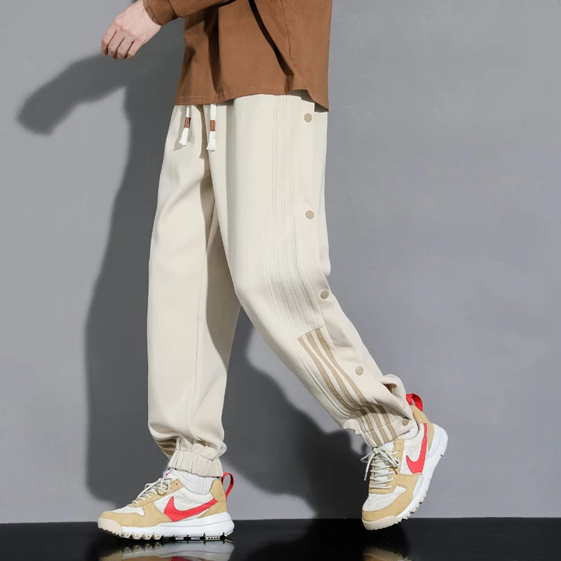 Men's relaxed fit snap-track joggers, ideal for everyday comfort & street style. Versatile men's athletic track pants.