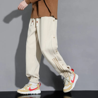 Men's relaxed fit snap-track joggers, ideal for everyday comfort & street style. Versatile men's athletic track pants.
