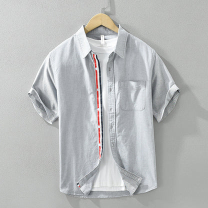 Close-up of lightweight, breathable men's casual button-up shirt fabric. Features a stylish striped pattern & quality buttons.