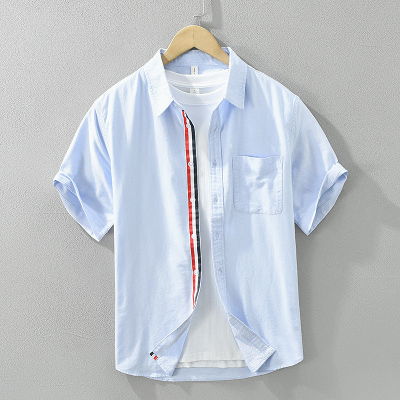 Model wearing a men's stylish short-sleeve striped button-up shirt. Perfect comfort fit for casual summer fashion.