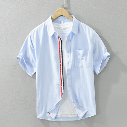 Model wearing a men's stylish short-sleeve striped button-up shirt. Perfect comfort fit for casual summer fashion.