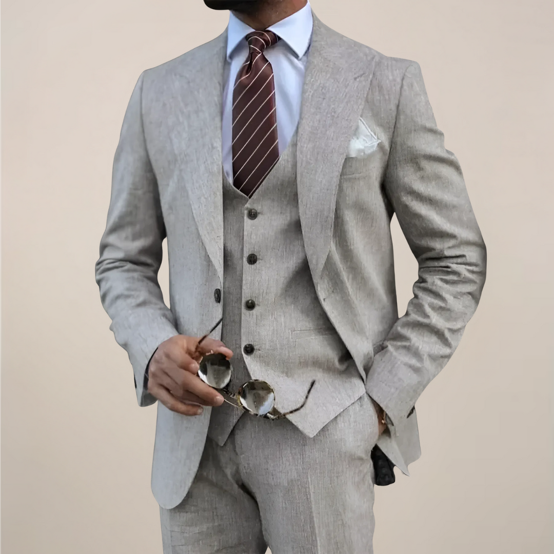 Men's stylish tailored three-piece suit in dark grey, perfect for formal events, business, and weddings.