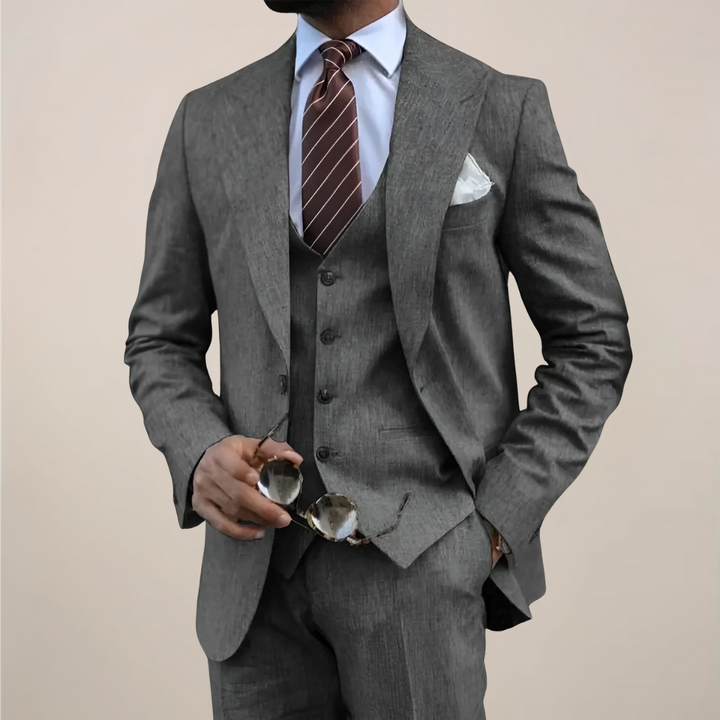 Elegant men's three-piece suit with a tailored jacket, vest, and trousers, ideal for a sharp formal look.