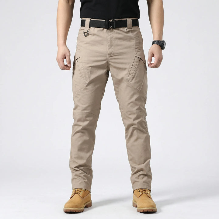 Front view: Men's durable tactical cargo pants, 9 pockets, designed for outdoor adventures, work, and hiking.