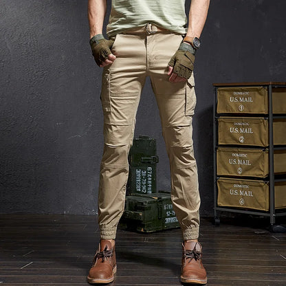 Man wearing rugged men's tactical cargo pants, tapered fit & cuffed ankles. Adventure wear for outdoor gear.